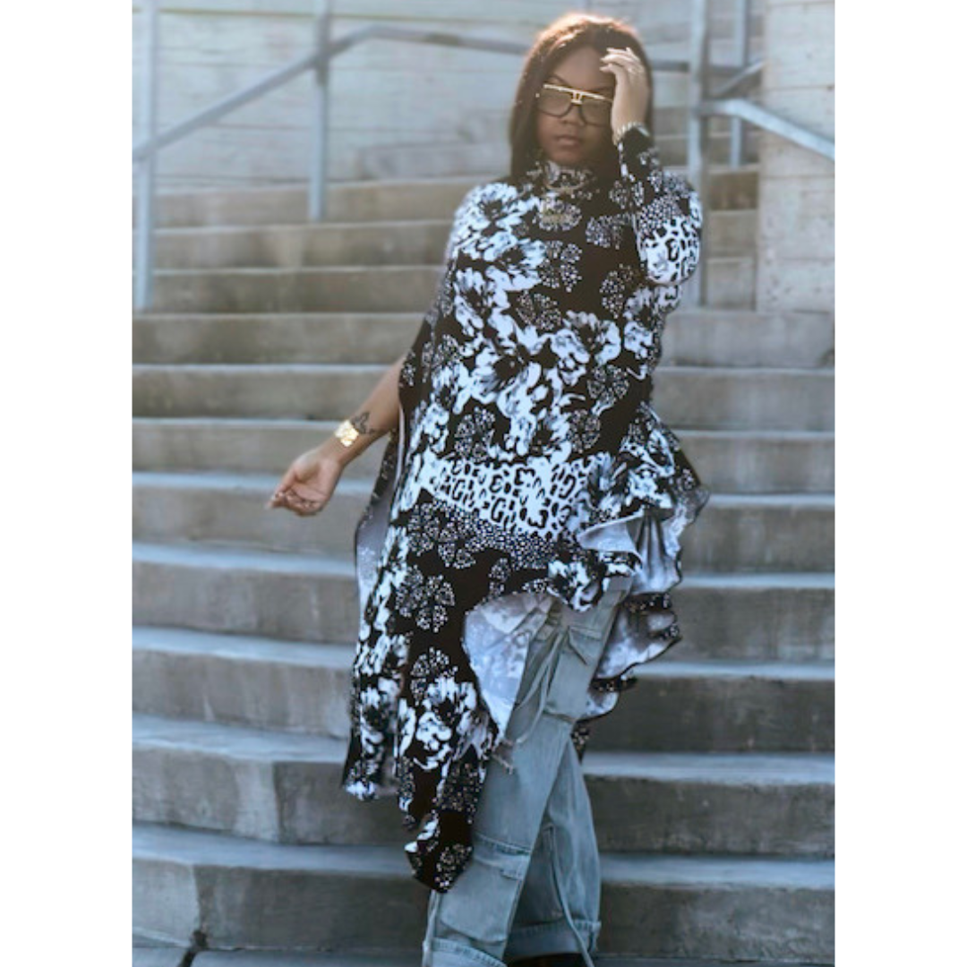 Side view of the LJ Jungle Couture Asymmetrical Blouse, emphasizing the unique high-low hemline and elegant drape.