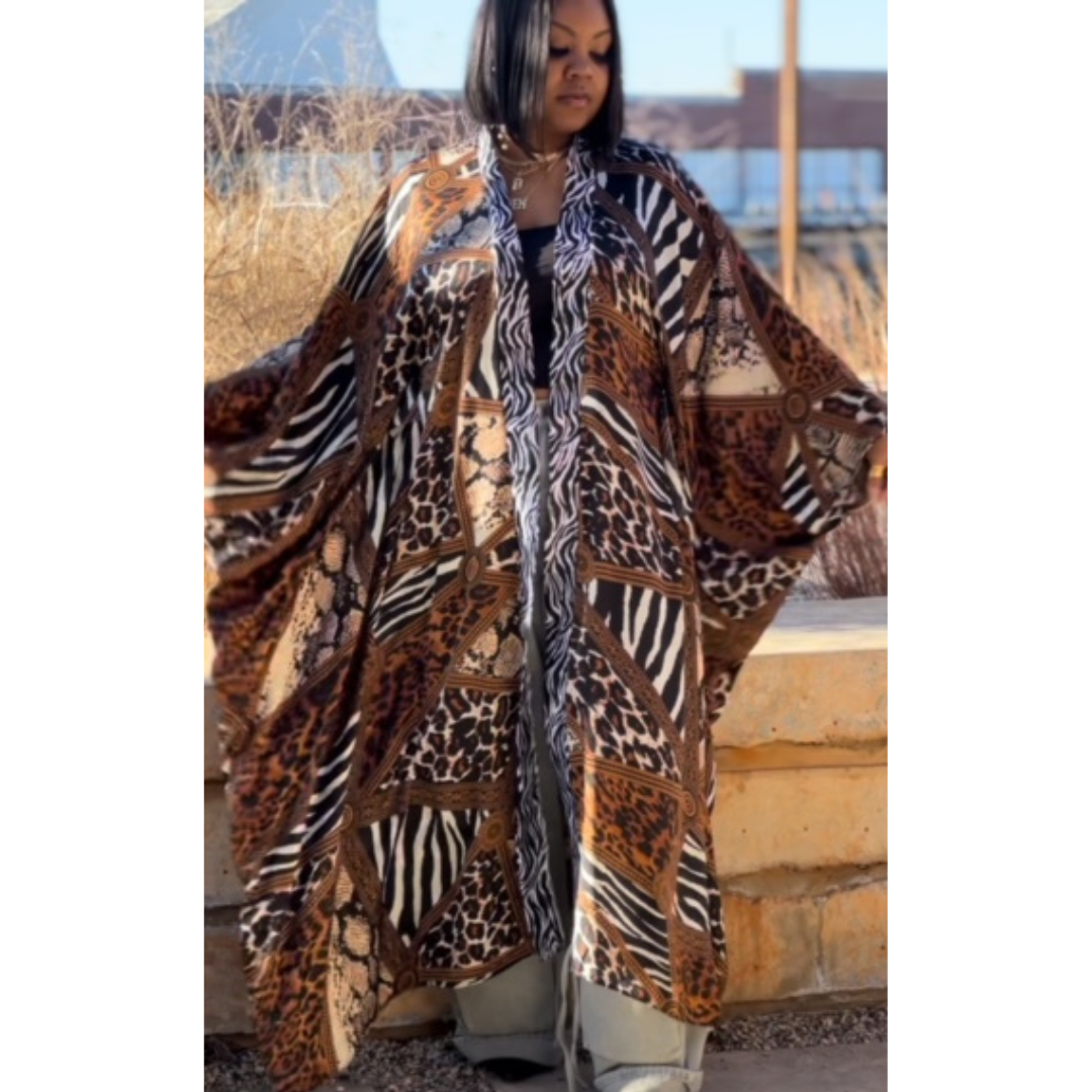 Model gracefully posing in the LJ Safari Serenity Kaftan Kimono, highlighting the luxurious fabric and sophisticated design.